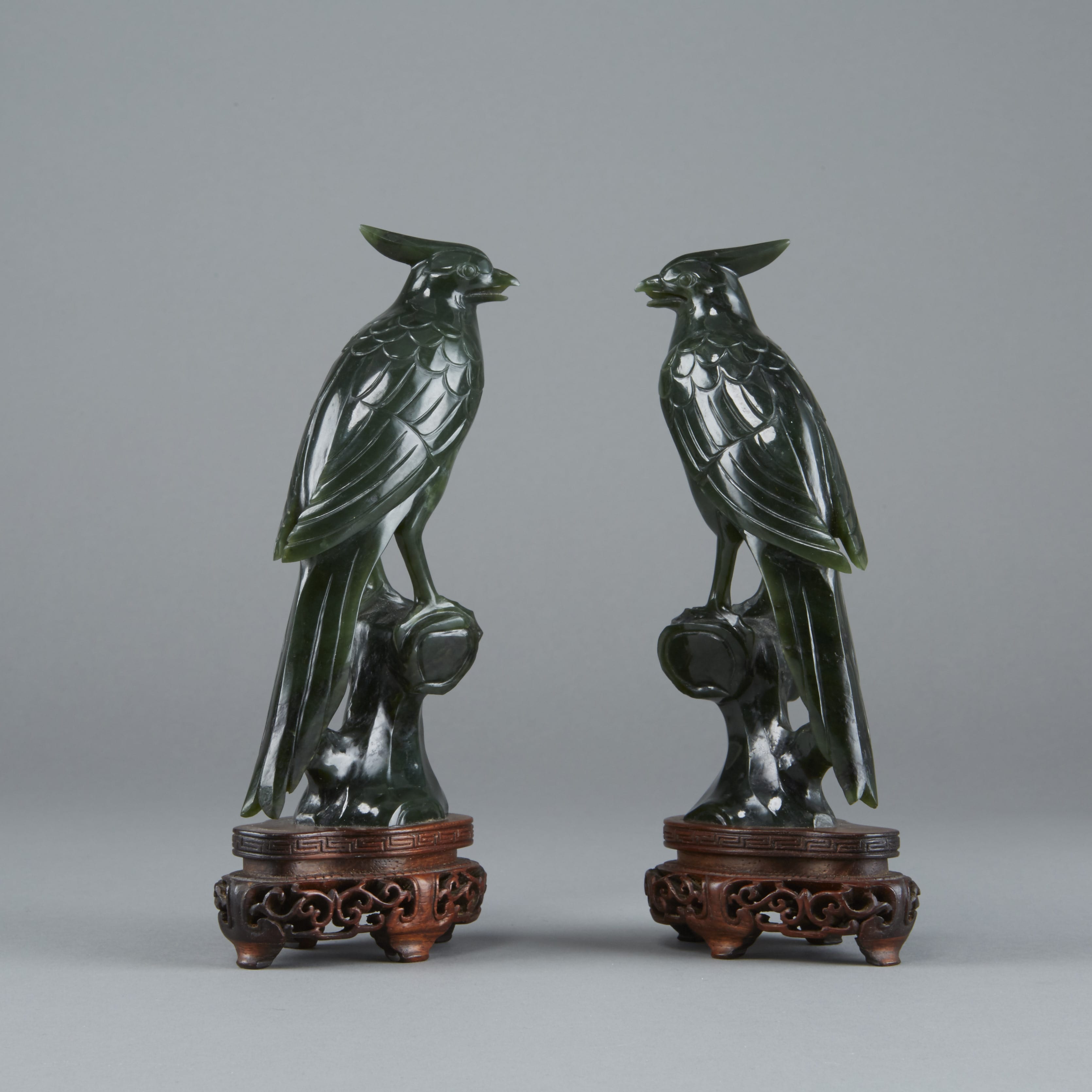 Lot 039: Pair of Chinese Late Qing or Republic period dark green Jade Birds on Original Stands