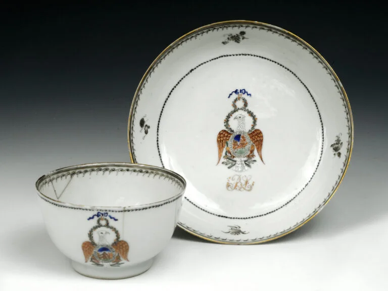 Chinese export porcelain teacup and saucer from the Benjamin Lincoln Society featuring an eagle crest.